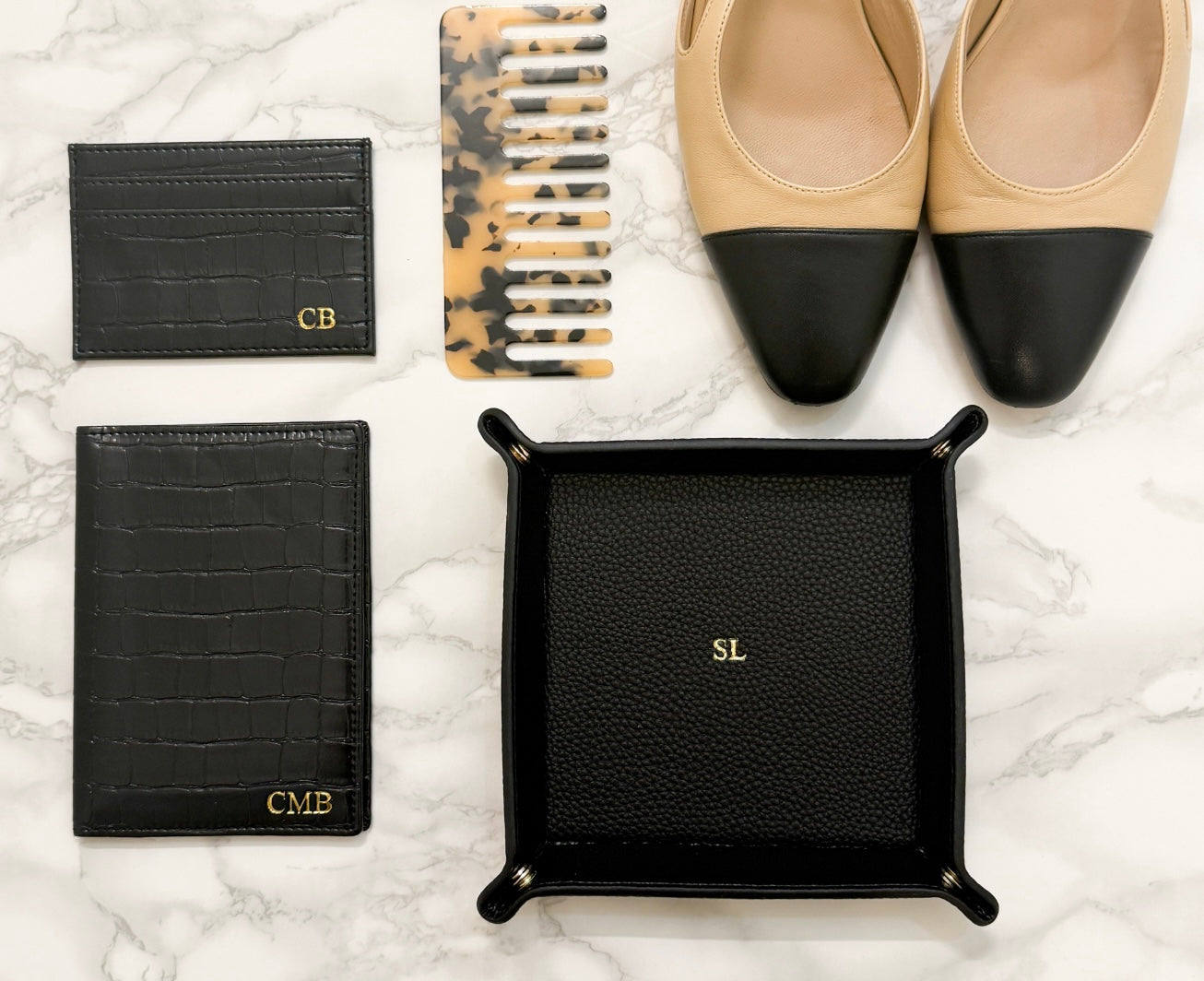 black cardholder, passport cover, catchall tray, with a comb, and shoes