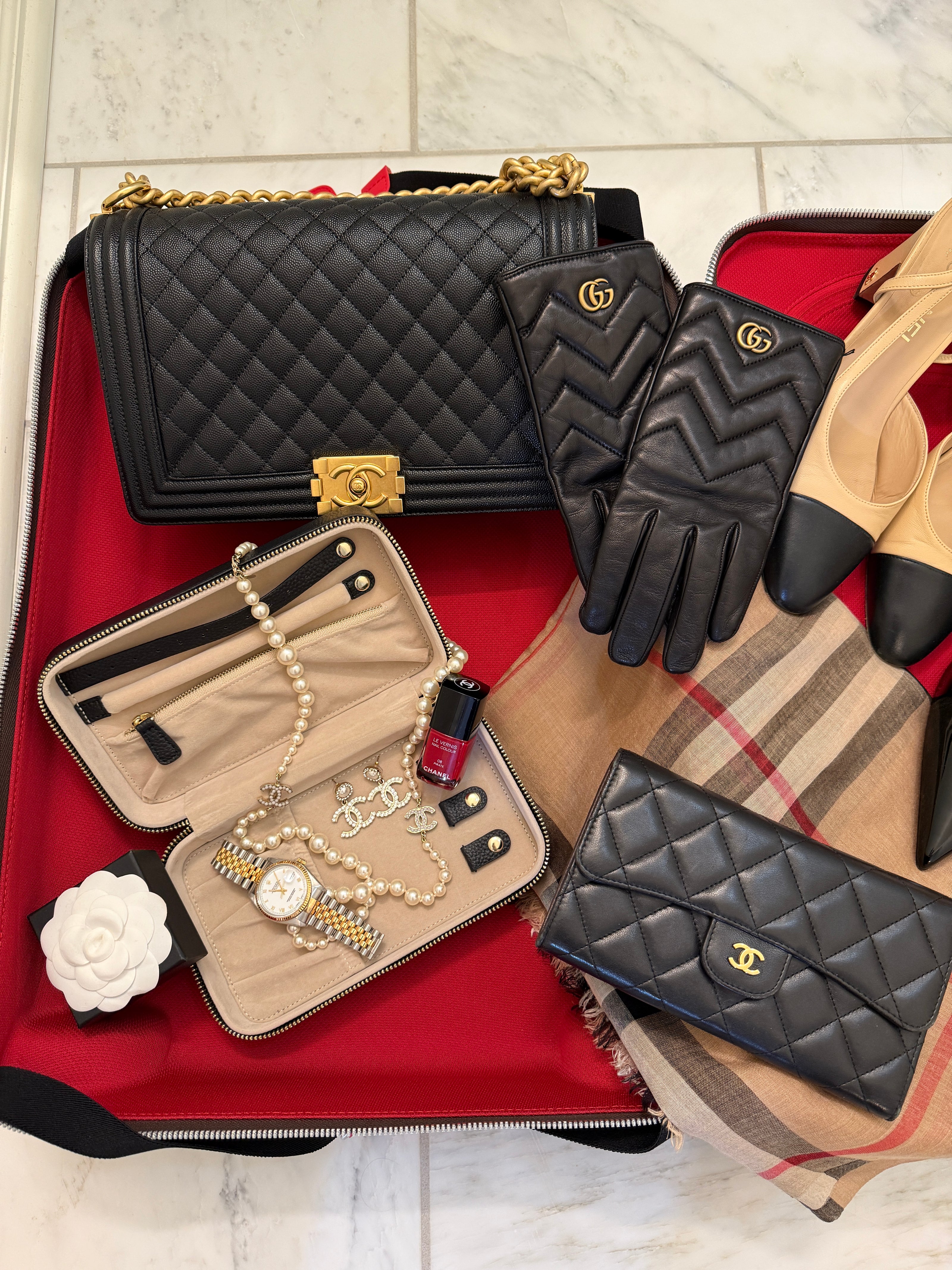 inside suitcase with handbag, jewelry case, wallet, gloves