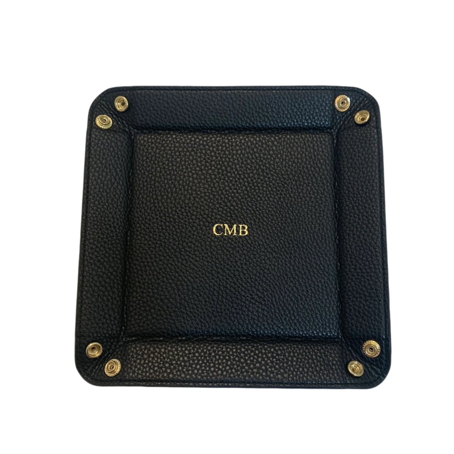 Black valet tray with a  gold monogram in the middle. 